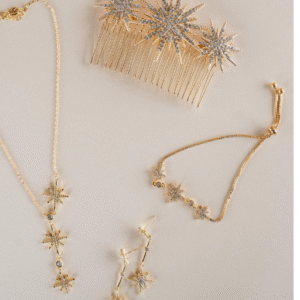 "Woman wearing minimalist gold necklace paired with white blouse"