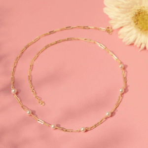 "Woman wearing layered gold chains with minimalist pendants"