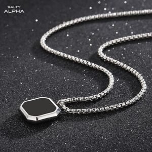 "Close-up of male neck with layered silver and leather necklaces"
