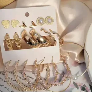 "Hoop earrings with dangling pearl charms and gold detailing"